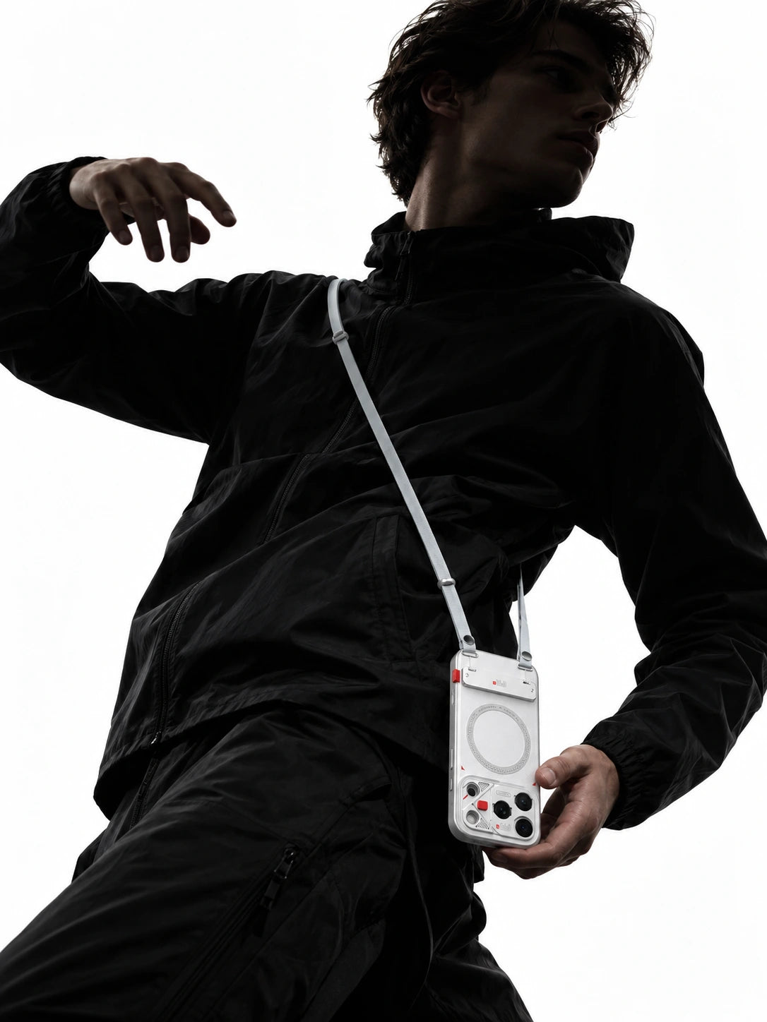 Dark techwear portrait against white with a brightly lit FR-N case and Maglink strap; AI-generated scene